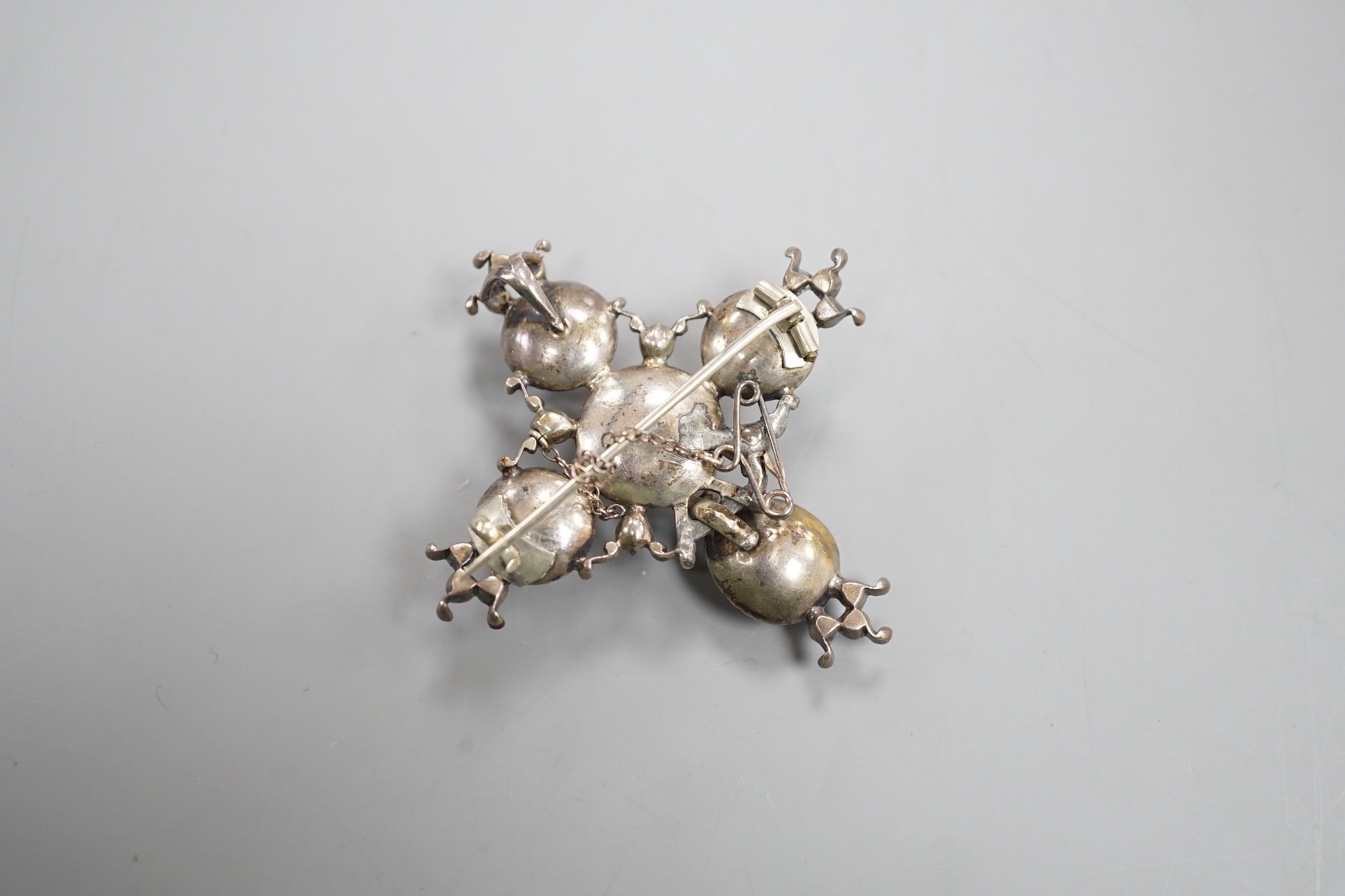 A 19th century white metal and paste cluster set quatrefoil shaped pendant brooch, 56mm, (a.f.).